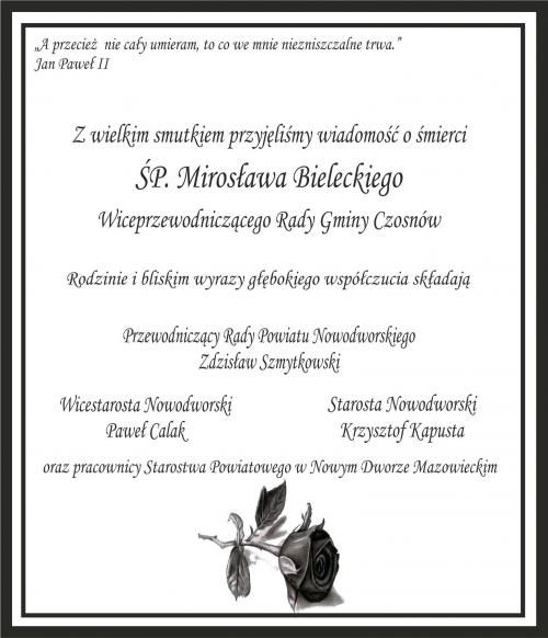 czarna ramka, czarne litery z tekstem, poniżej czarna róża
