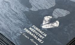 Fragment granatowej teczki, logotyp Fundacji im. Ernesta Wójcickiego
