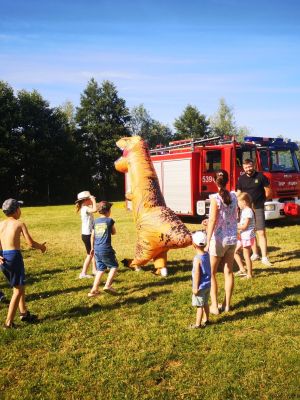 zabawa najmłodszych uczestników wydarzenia z dmuchanym dinozaurem