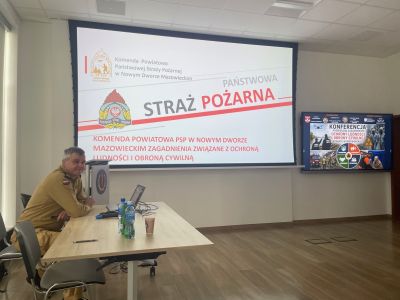 Komendant Powiatowy Państwowej Straży Pożarnej prezentuje materiał szkoleniowy podczas konferencji